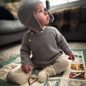 hand knitted baby cardigan and matching bonnet