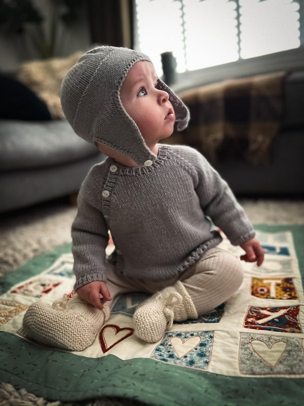 hand knitted baby cardigan and matching bonnet